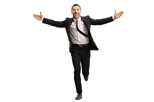 Full length portrait of a businessman running and spreading arms isolated on white background